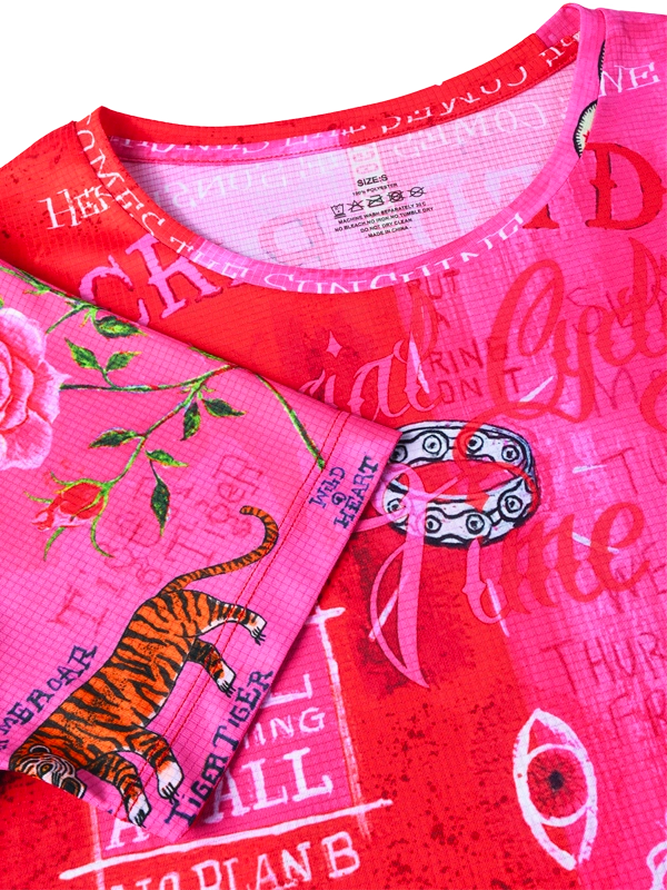 Close-up of a pink and red tech tee shirt with graphic designs and text.