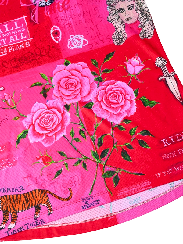 Close up of Red fabric with pink roses, a tiger, and text 