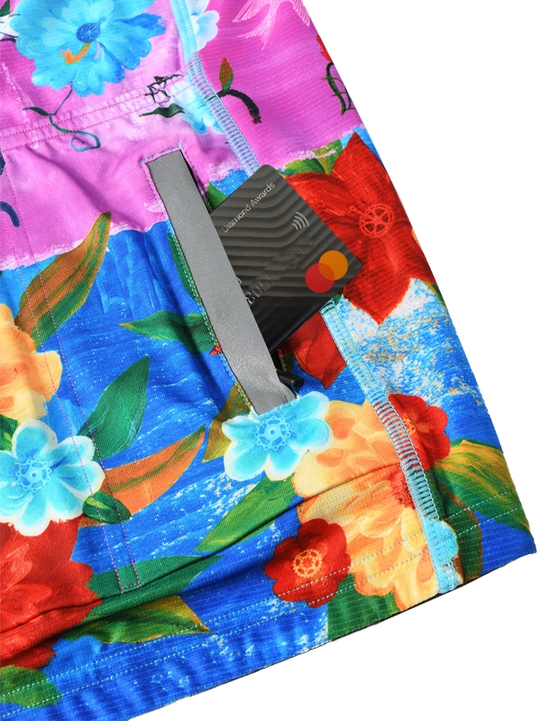 Colorful cycling jersey with floral design and 'cycology' branding on a pink and blue background back pockets 