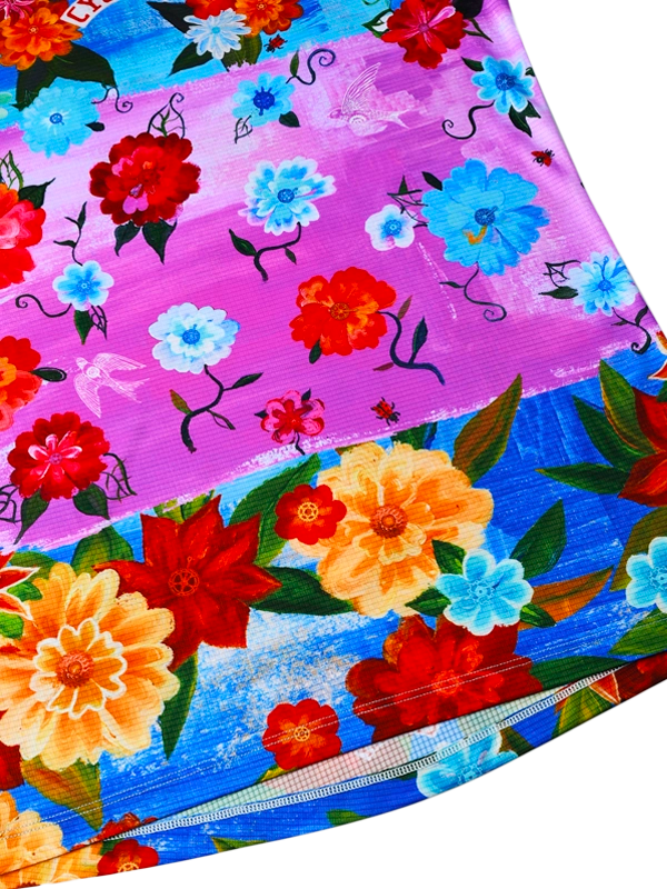 Colorful floral patterned paper with red, blue, and yellow flowers on a purple and blue background.