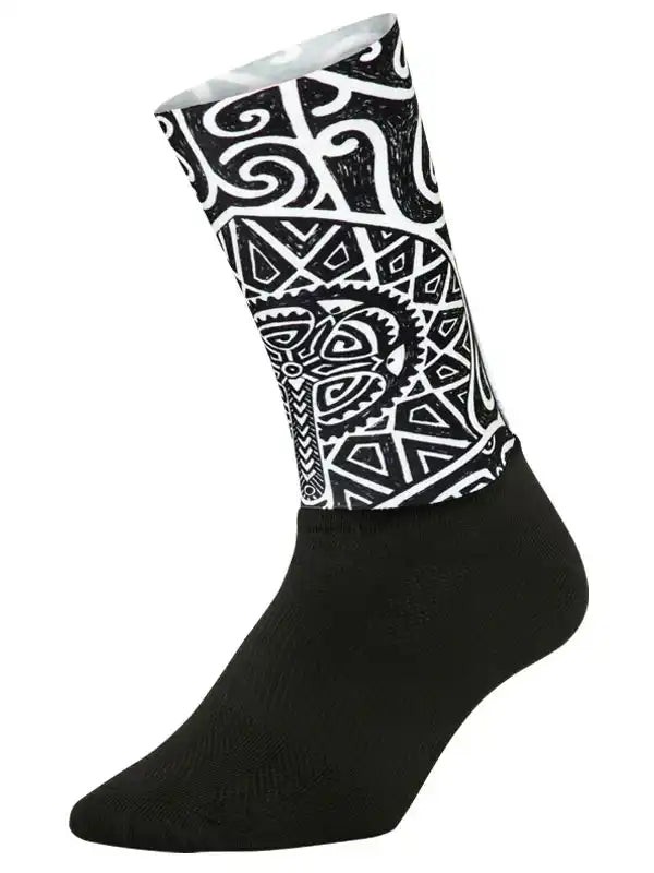 Black cycling sock with bold white Maori-inspired geometric pattern, ideal for men's and women's bike rides.