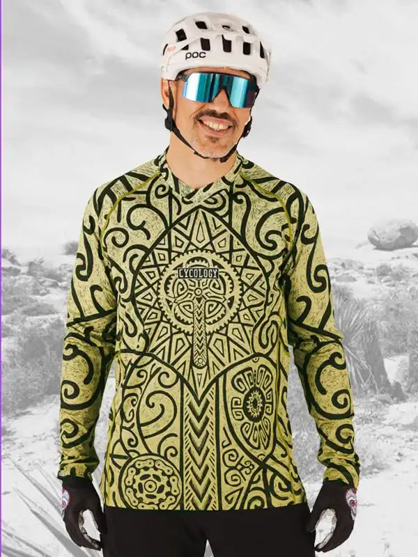 Man wearing patterned cycling jersey, helmet, and sunglasses for mountain biking