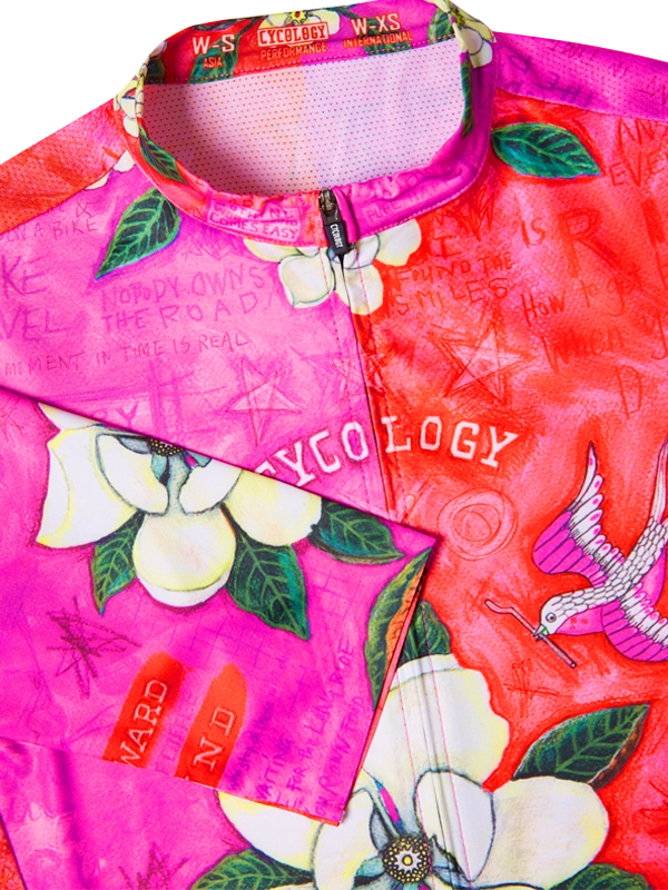 Colorful jersey with floral designs and text on a bright pink background