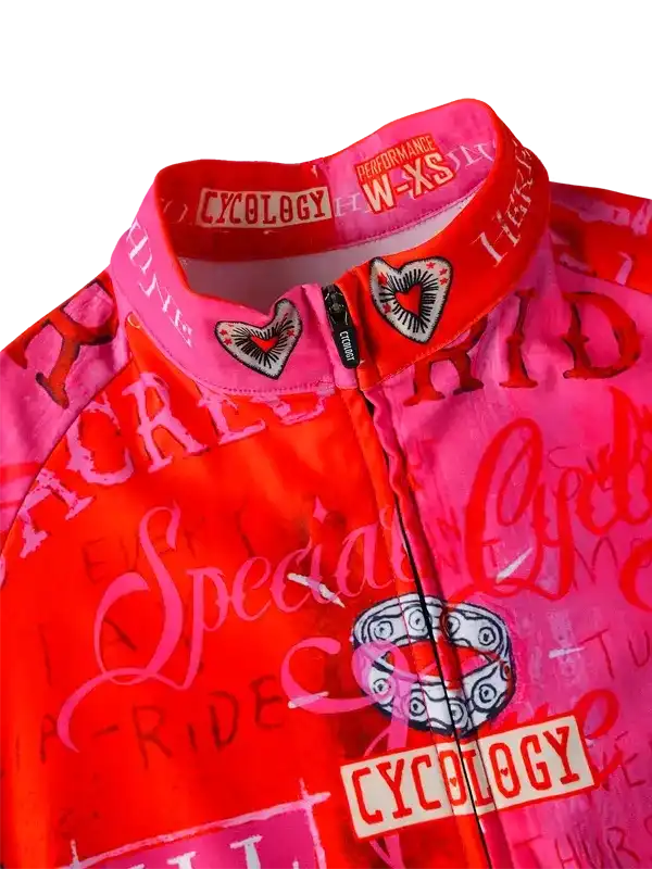 Vibrant pink and red women's cycling jersey with heart graphics, 'Special Ride' text, and performance W-XS sizing label