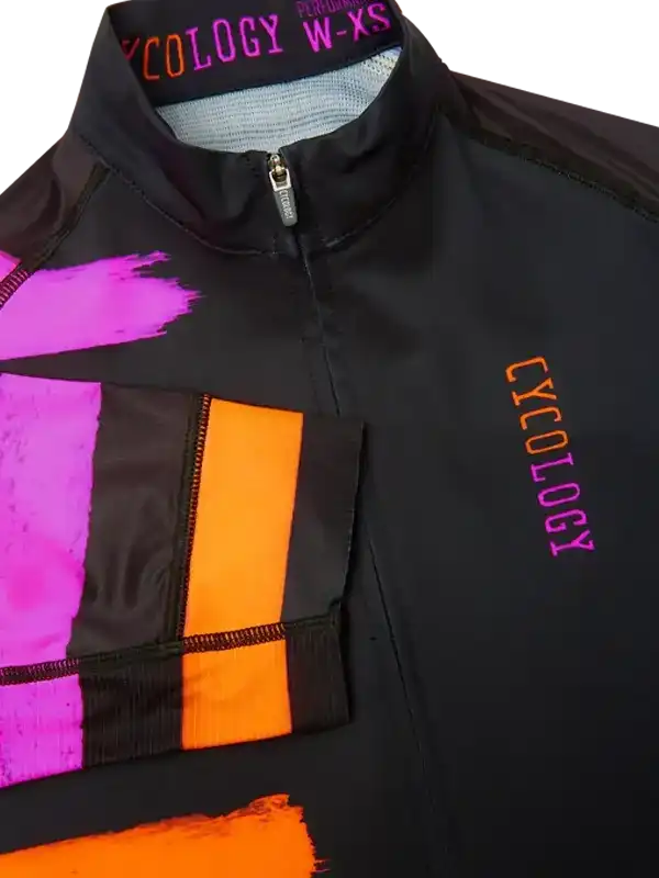 Black cycling jersey with vibrant pink and orange geometric designs, featuring 'CYCOLOGY' branding.