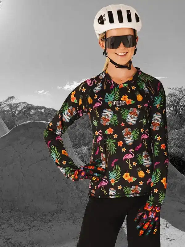 Woman in tropical print cycling jersey, helmet, and sunglasses, ready for a ride