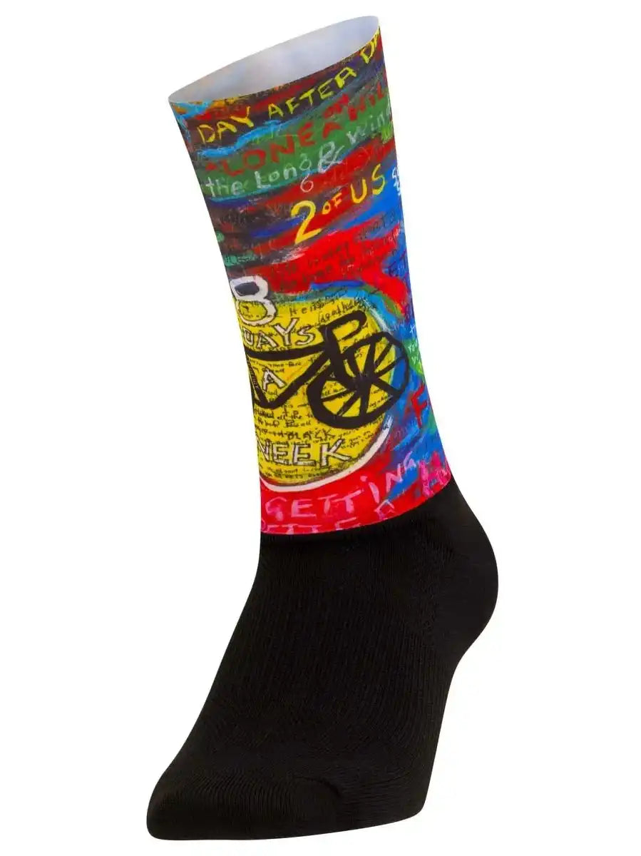 Colorful cycling sock with bike graphic and text design, black foot, vibrant patterns for cyclists