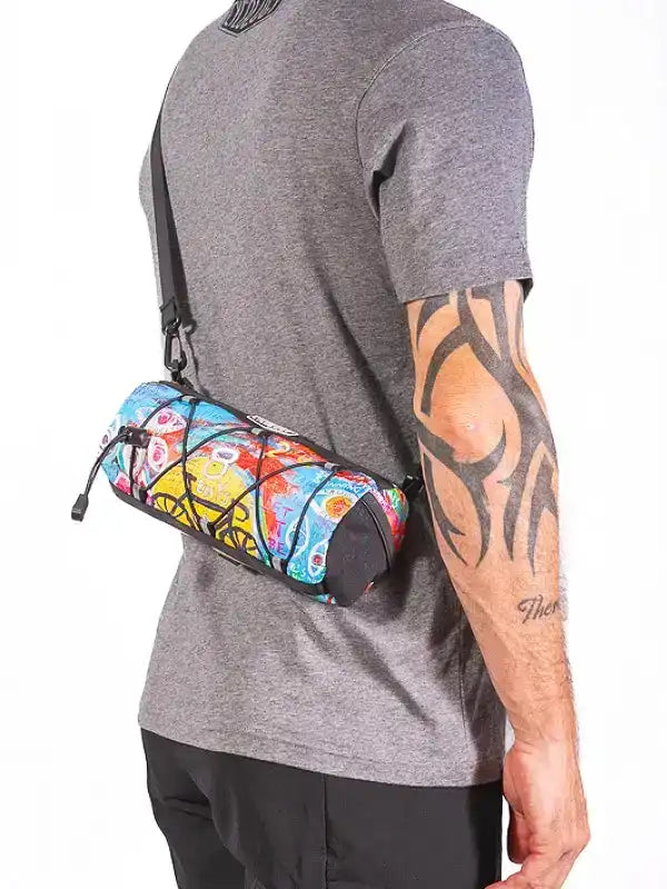 Colorful cycling waist bag with vibrant pattern, worn by man in gray shirt, ideal for bike rides and outdoor activities.