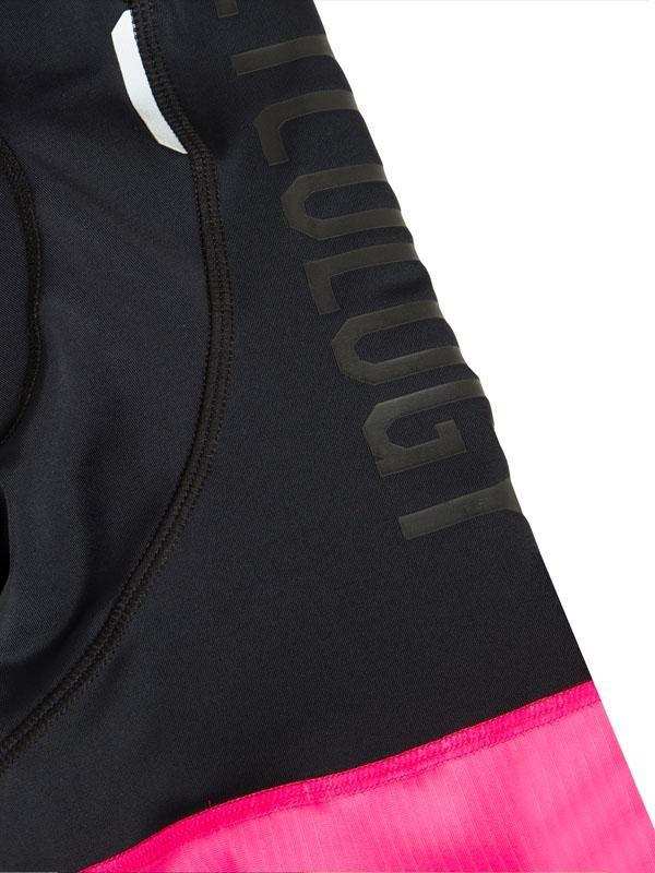 Black cycling shorts with pink hem and 'CYCOLOGY' branding, designed for comfort and performance.