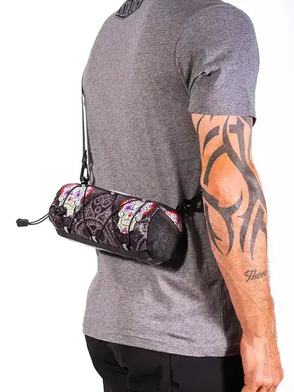 Men's cycling waist bag with sugar skull print, worn over gray tee for bike rides
