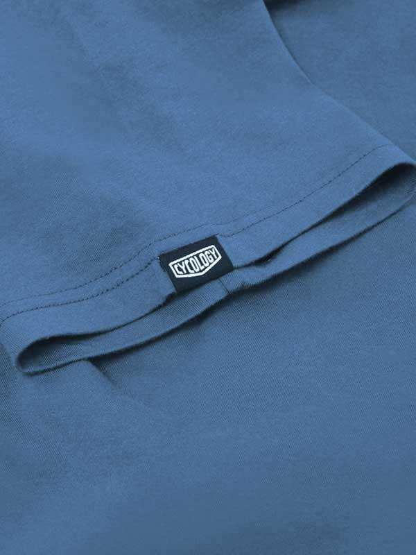 Blue cycling jersey with Cycology brand tag, showcasing high-quality fabric and design detail.