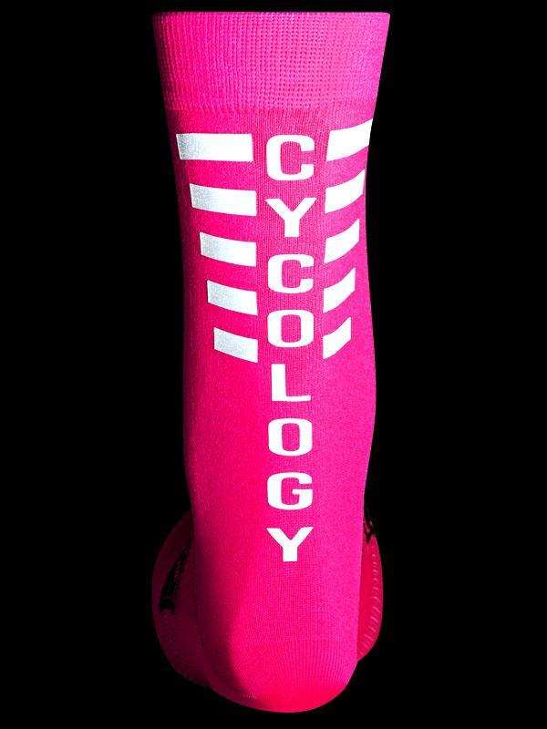 Bright pink cycling sock with white 'CYCOLOGY' text and reflective stripes, designed for performance and visibility.