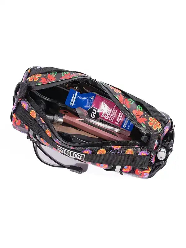Floral cycling frame bag with energy gels and tools, ideal for bike rides and adventures.