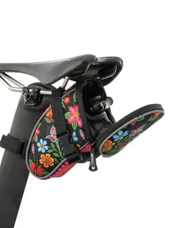 Colorful floral bike saddle bag with zipper, attached to bicycle seat for cycling storage