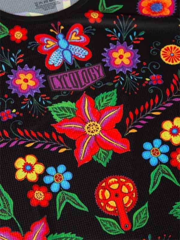 Vibrant floral and butterfly print cycling jersey with bold colors and bike gear motifs on black fabric