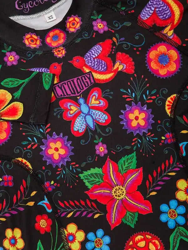 Vibrant floral and bird pattern cycling jersey with bold colors and intricate designs