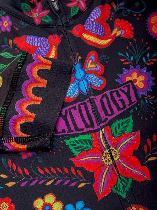 Vibrant floral and bird print cycling jersey with bold colors and 'CYCOLOGY' logo