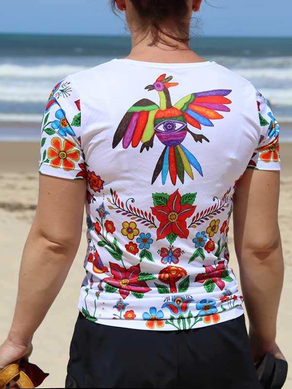 Women's cycling jersey with colorful bird and floral print, beach backdrop