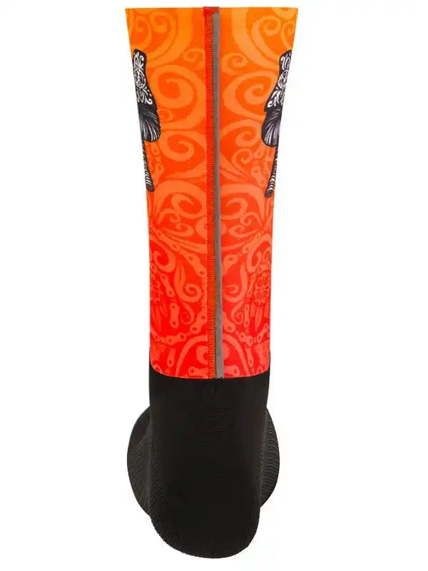 Vibrant orange cycling sock with swirl pattern and black accents, designed for comfort and style on rides.