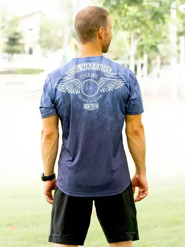 Men's cycling jersey with 'Road Warriors' graphic, wings, and bike wheel design, ideal for road cycling apparel.