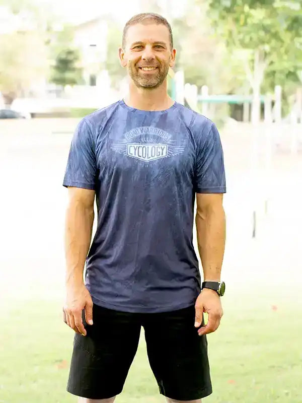 Man wearing blue Cycology cycling jersey with 'Cycology' logo, ideal for men's cycling apparel