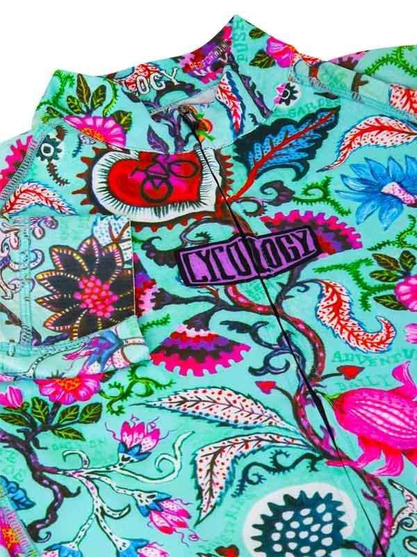 Vibrant floral cycling jersey with bold patterns and zipper detail, ideal for men's and women's rides.