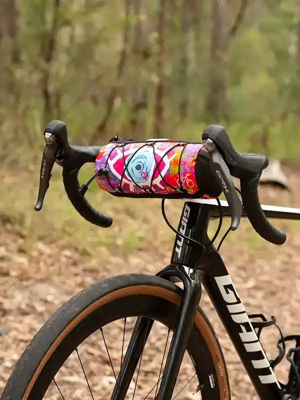 Colorful cycling frame bag on bike handlebars, perfect for road rides and outdoor adventures.