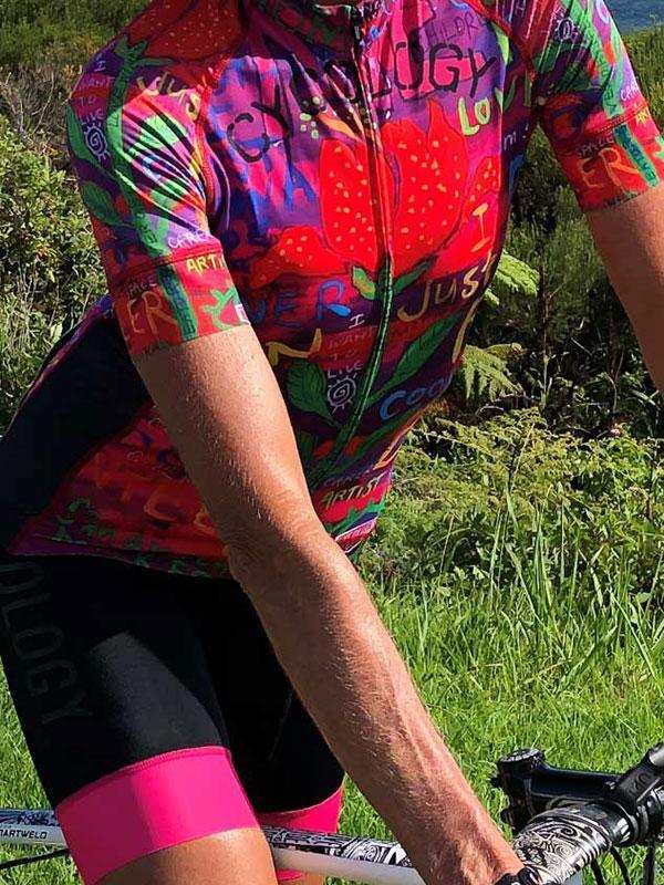 Vibrant floral cycling jersey with bold graphics, worn on a trail ride, showcasing performance fabric and fit.