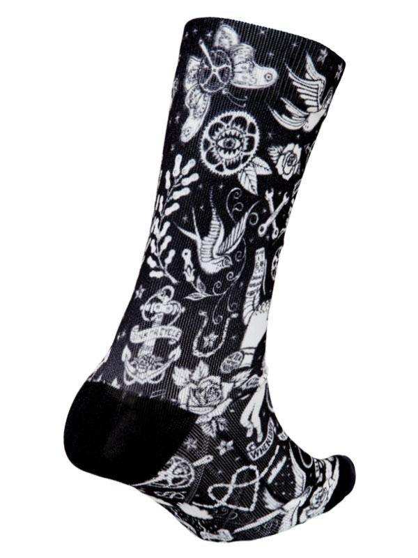 Black cycling sock with white tattoo-style designs including roses, anchors, and birds