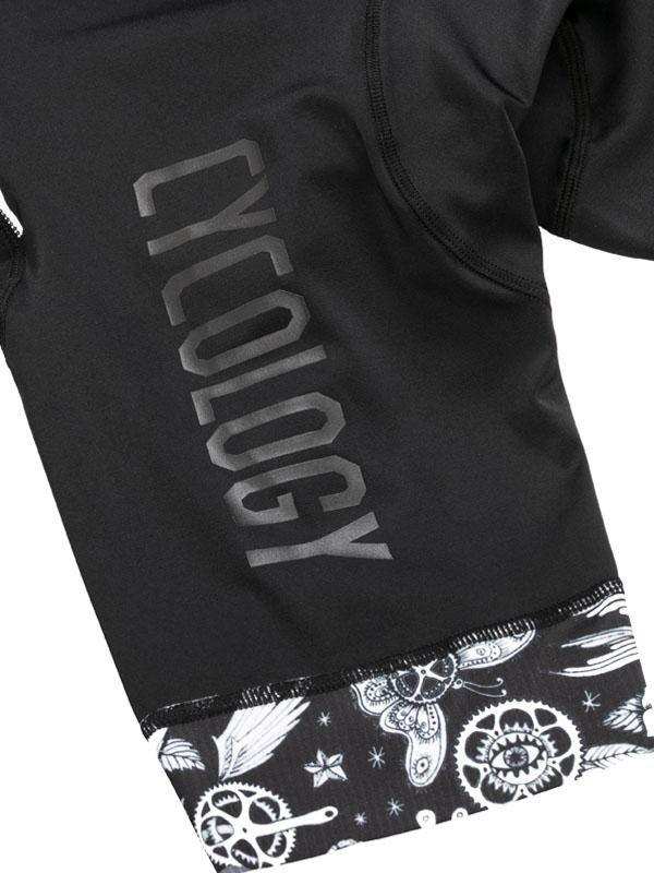 Black cycling jersey with 'CYCOLOGY' logo and gear-wing print hem, performance fabric
