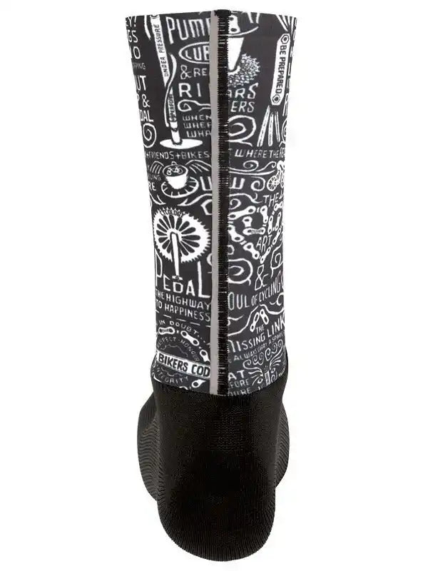 Black cycling shoe cover with white bike-themed graphics and text, featuring gear and pedal designs
