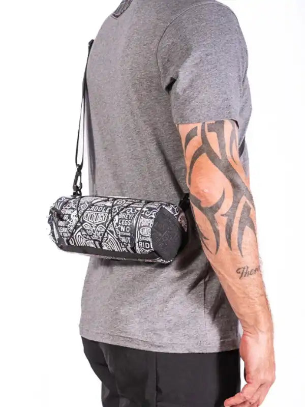 Men's cycling waist bag with graphic print, worn over gray tee for active rides